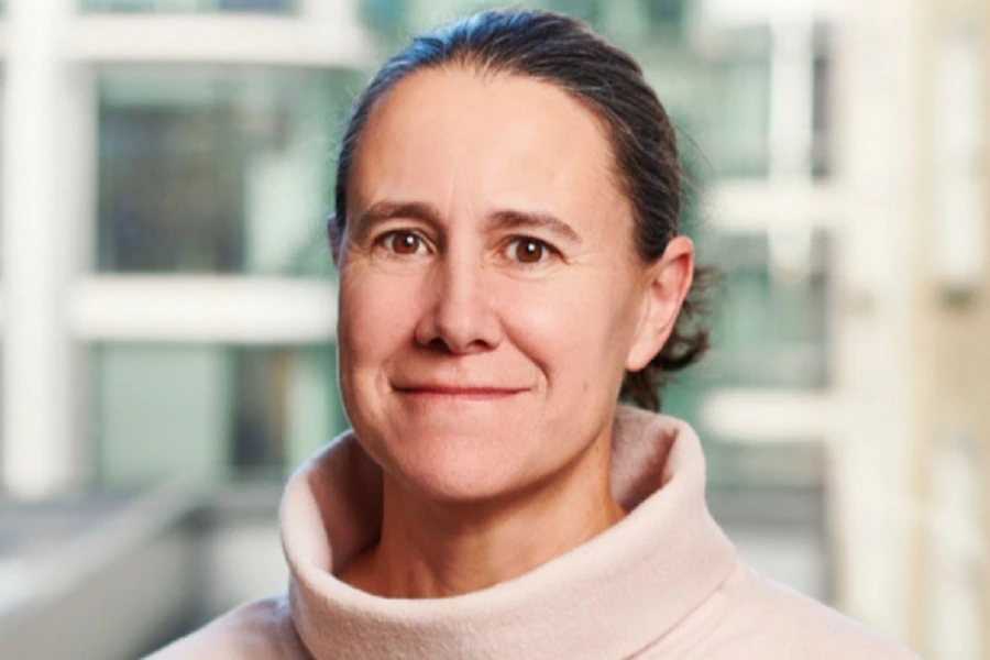 mature woman in peach sweater smiling
